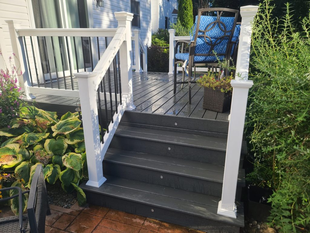 Stairs in Trex composite with white vinyl hand rail.