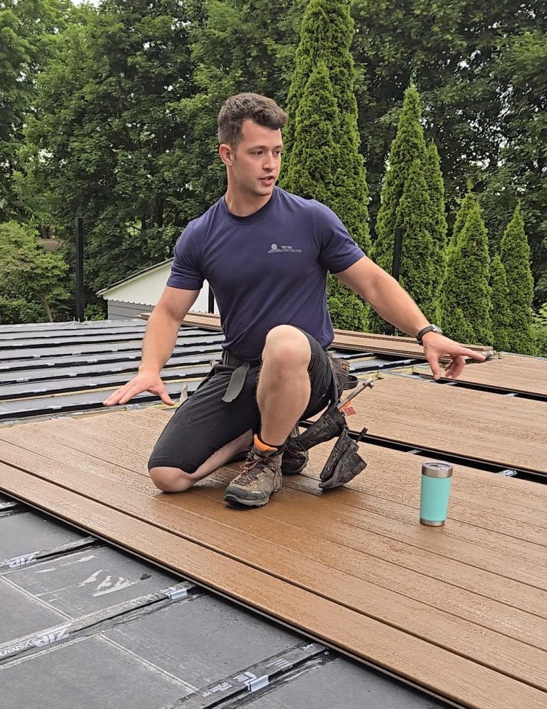 Carpenter installing composite decking