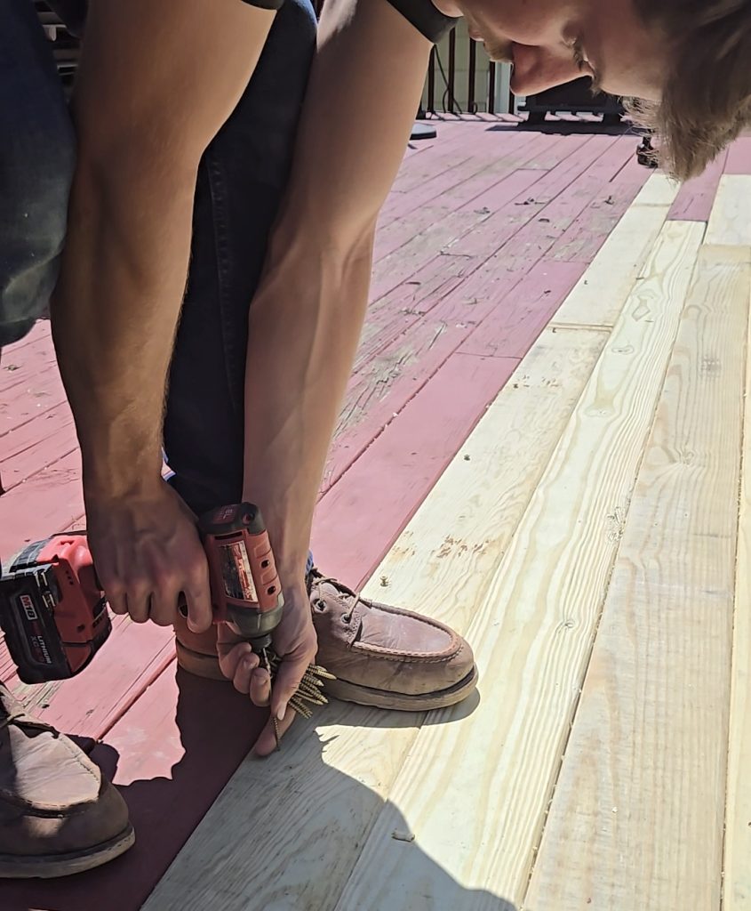 Carpenter installing wood decking