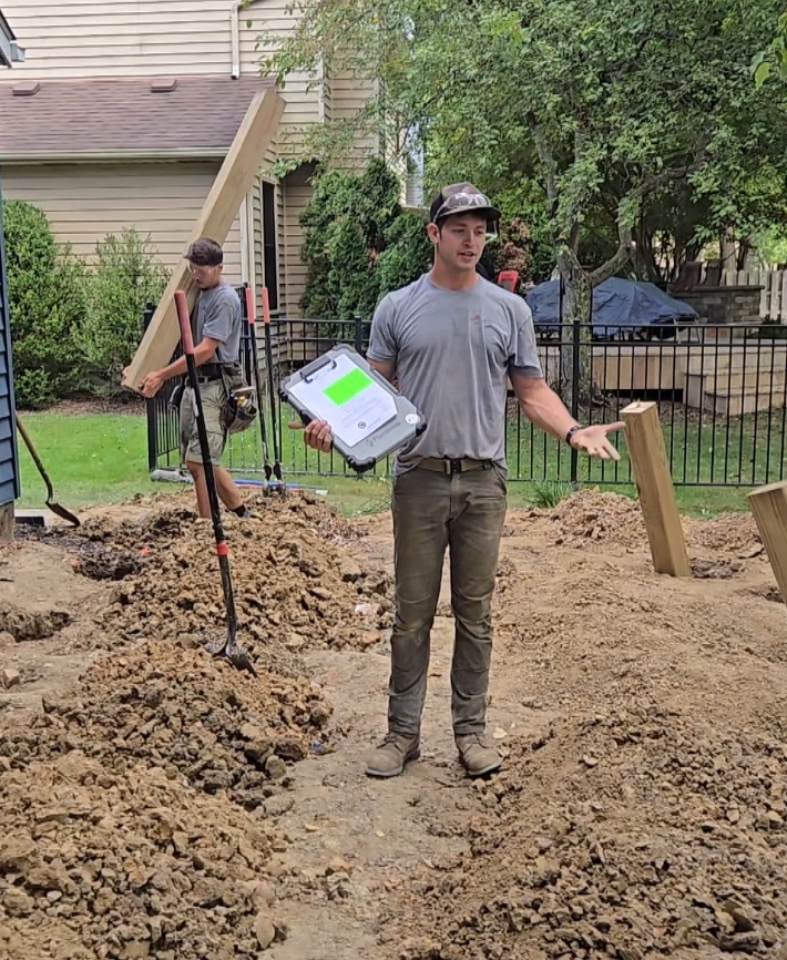 man digging post holes